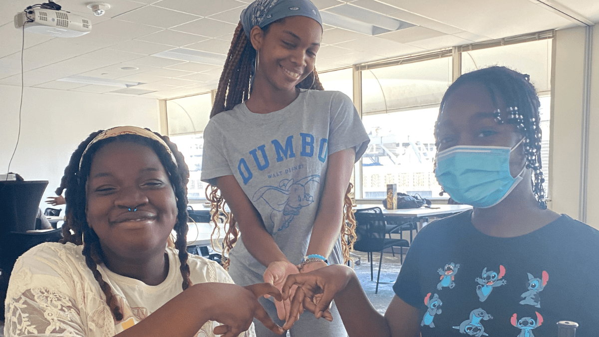 Philadelphia students Phatamarha, El-Veta, and Jay at a Summer Game Night student event.